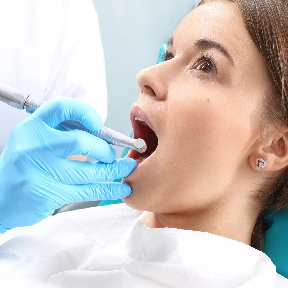 Patient undergoing a dental cleaning after root canal treatment at Dental Art Clinic in Cambridge.