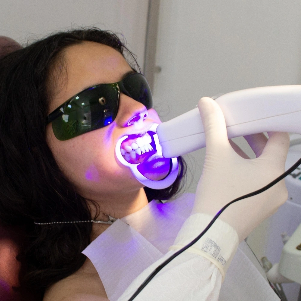 Patient undergoing LED teeth whitening treatment at Dental Art Clinic