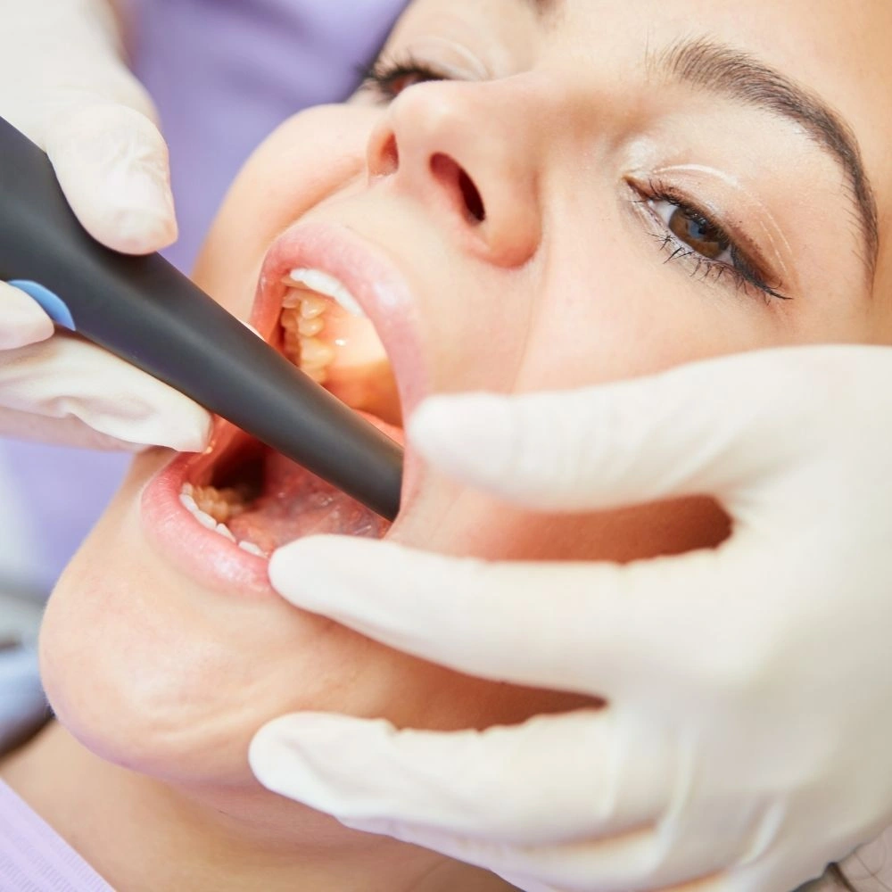 Patient receiving an intraoral camera exam for detailed dental assessment at Dental Art Clinic in Cambridge