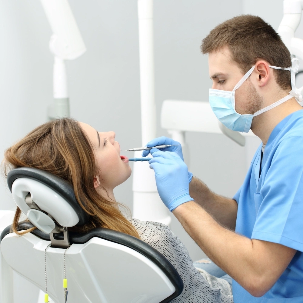 Dentist performing endodontic root canal treatment on a patient at Dental Art Clinic in Cambridge.