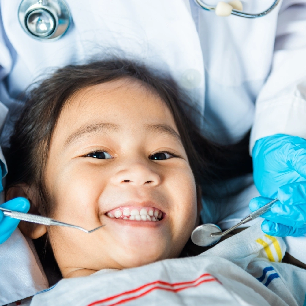 Child smiling during a gentle dental checkup at Dental Art Clinic in Cambridge