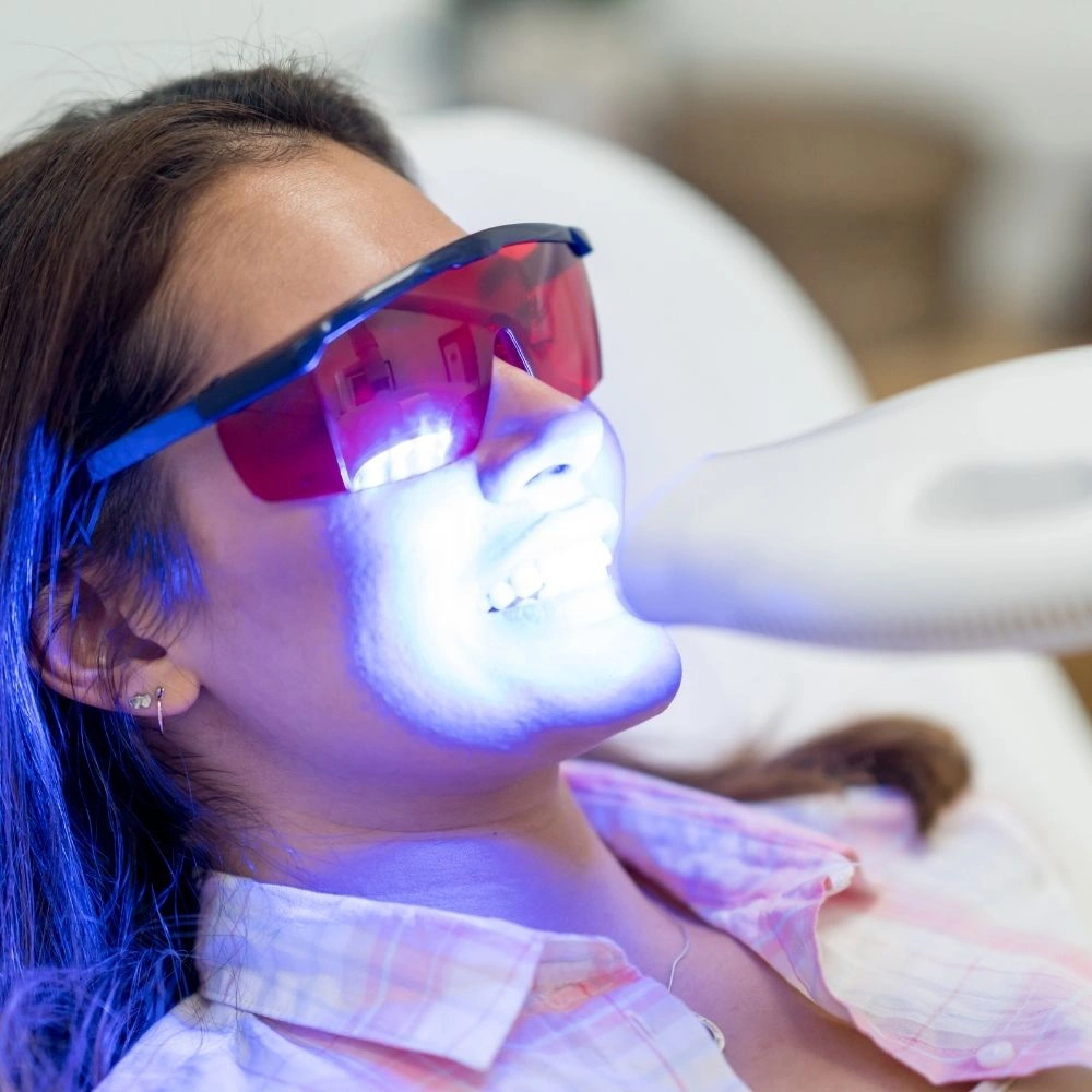 Patient undergoing Zoom teeth whitening with protective eyewear at Dental Art Clinic in Cambridge