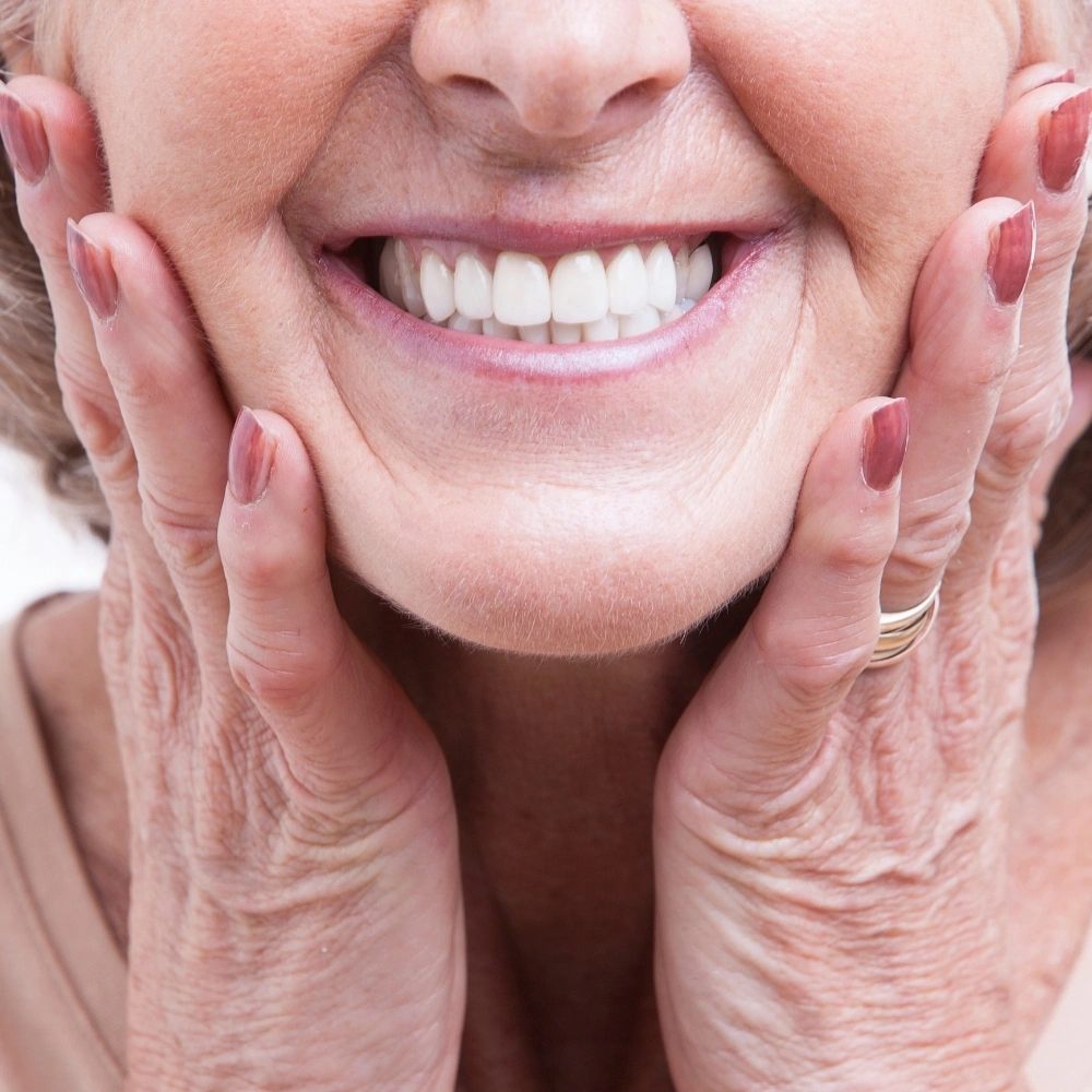 Close-up smile showing natural-looking dentures at Dental Art Clinic in Cambridge