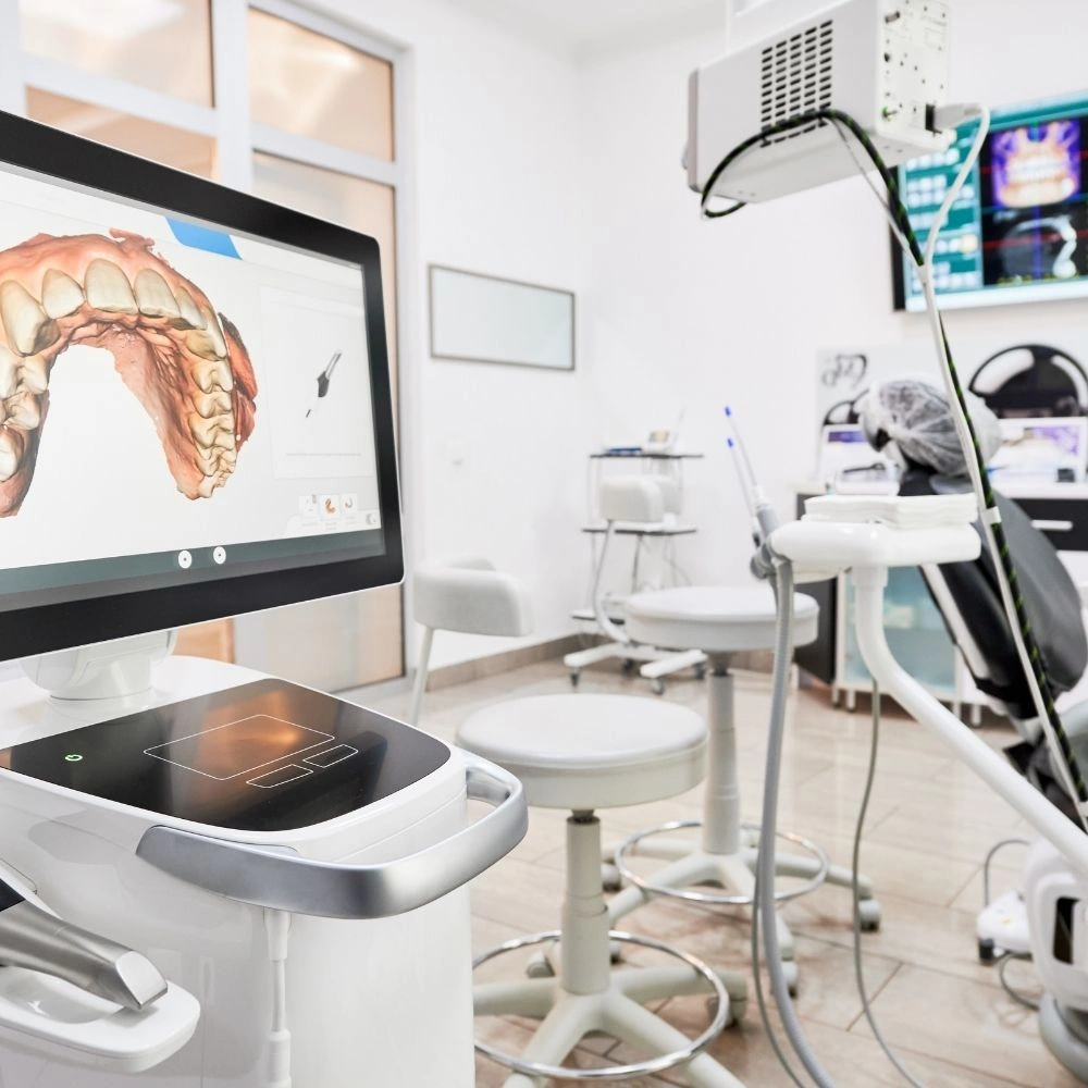 Advanced digital dental equipment and 3D imaging system inside a treatment room at Dental Art Clinic in Cambridge.